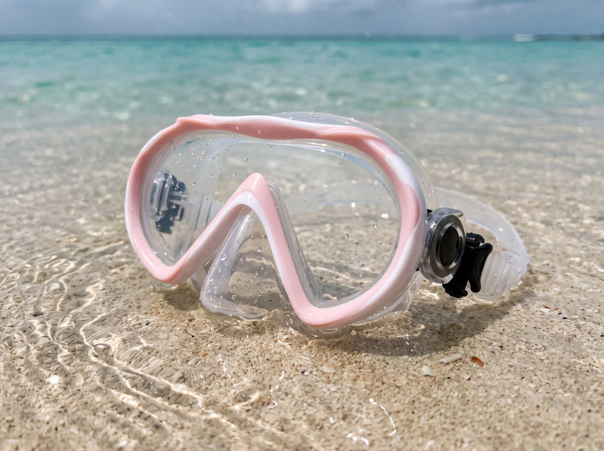 Tilos Cosmos Jr junior snorkeling mask in white and pastel pink in the water at the shoreline shallows