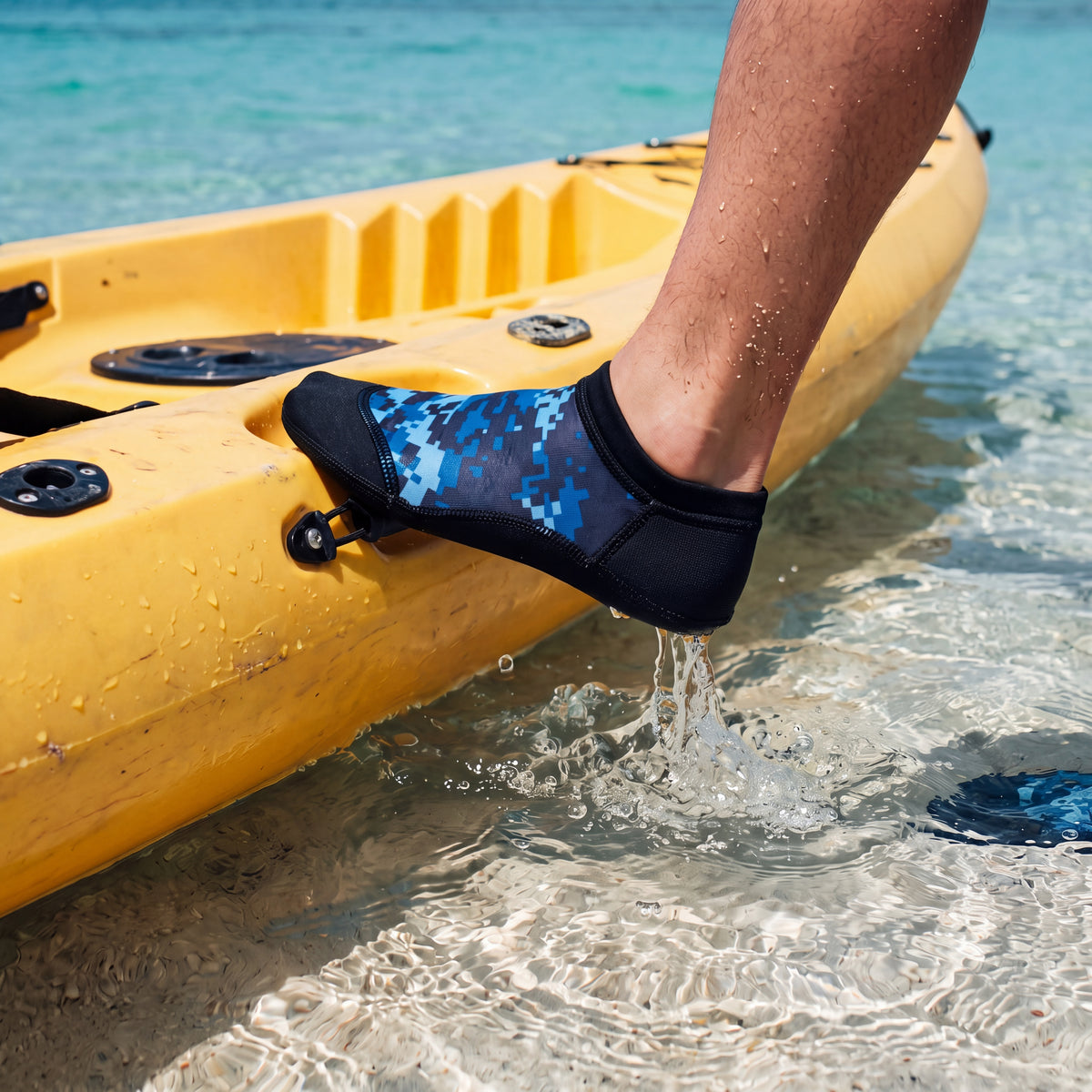Kayaker stepping out of a kayak into clear shallows wearing the digital blue camo Tilos 2.5mm Low Cut Sport Skin Socks