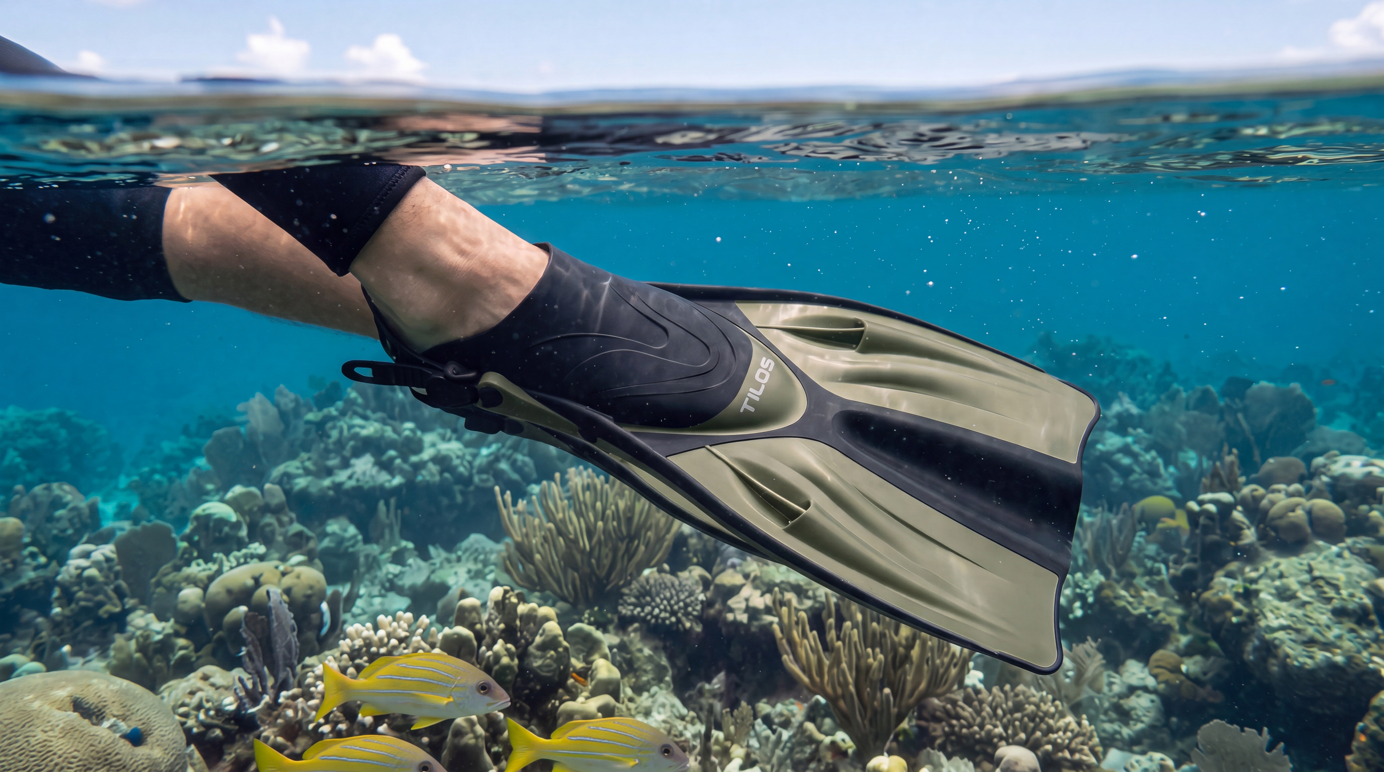 Tilos Getaway titanium fin at the surface, split-level over-under reef view