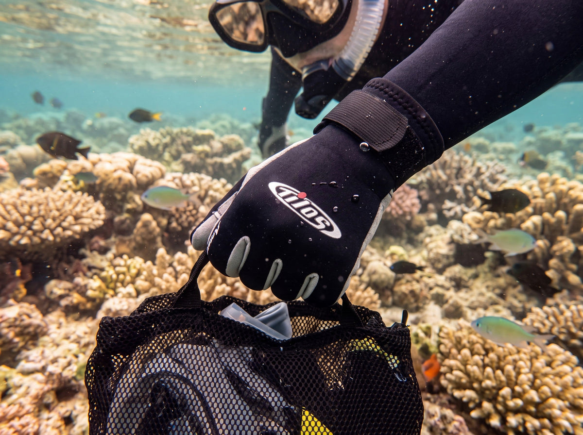 Snorkeler in Tilos 1.5mm Tropical-X Neoprene Gloves holding a mesh gear bag over a tropical reef