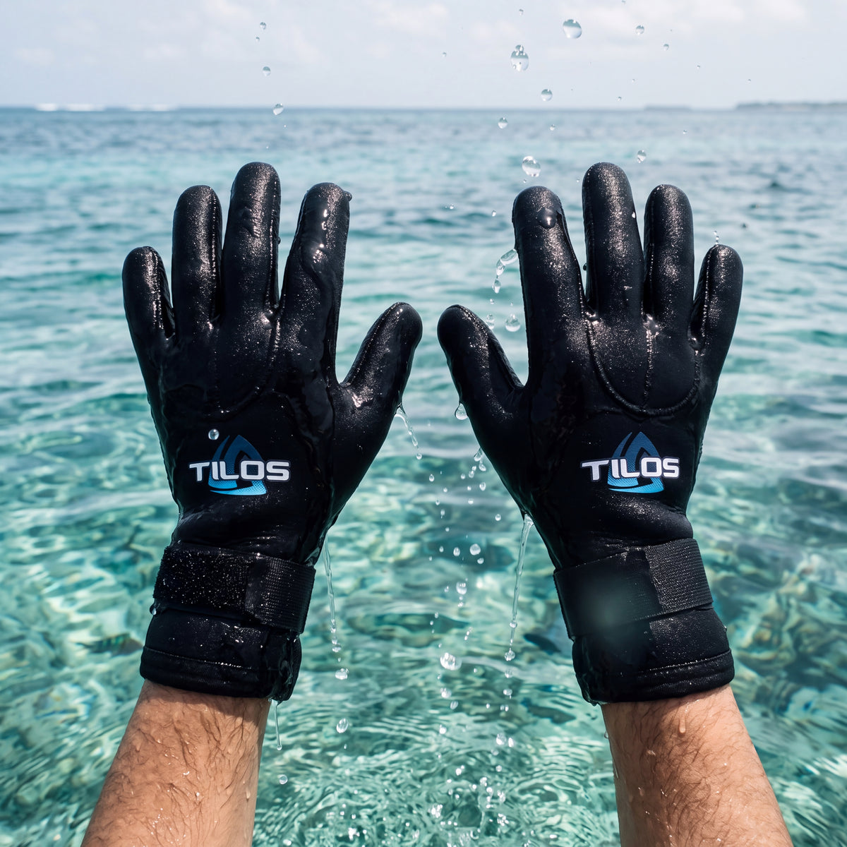 Diver at the surface holding up both hands wearing black Tilos 5mm Titanium neoprene dive gloves, blue Tilos logo on the back of each hand.